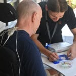 A client wearing the ARC-EX completes tasks during a therapy session at STEPS