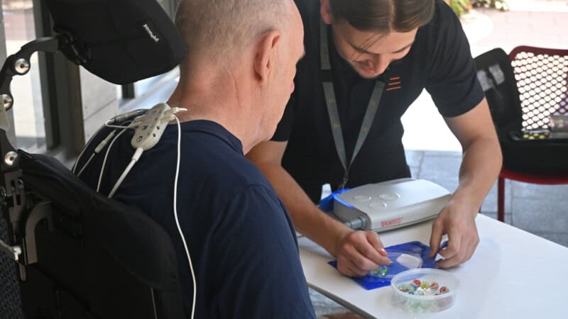 A client wearing the ARC-EX completes tasks during a therapy session at STEPS